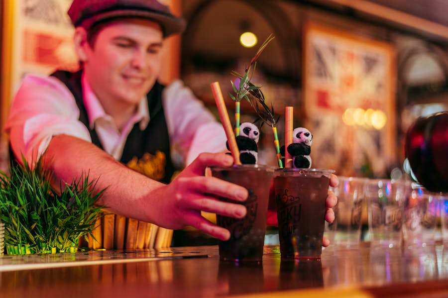Bartender serving 2 Berry Pop Bubble Cup cocktails