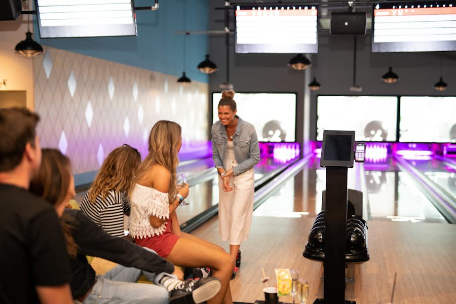 group of friends bowling at strike carousel