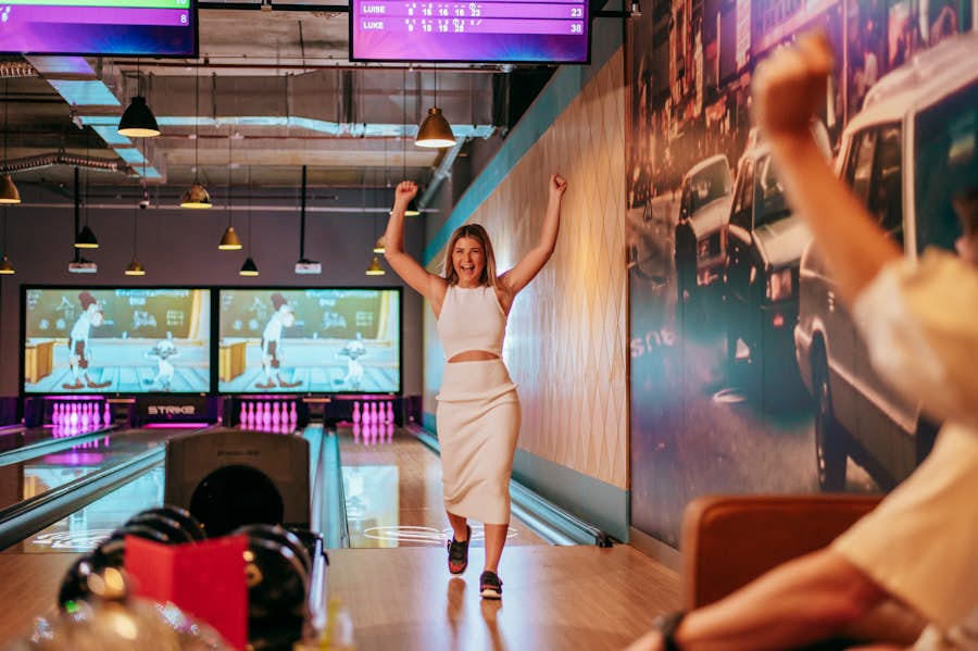 woman celebrating on the bowling lanes at Strike forrest chase in perth