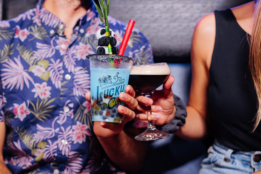 Close up of people holding the Berry Pop Bubble Cup cocktail and Espresso Martini