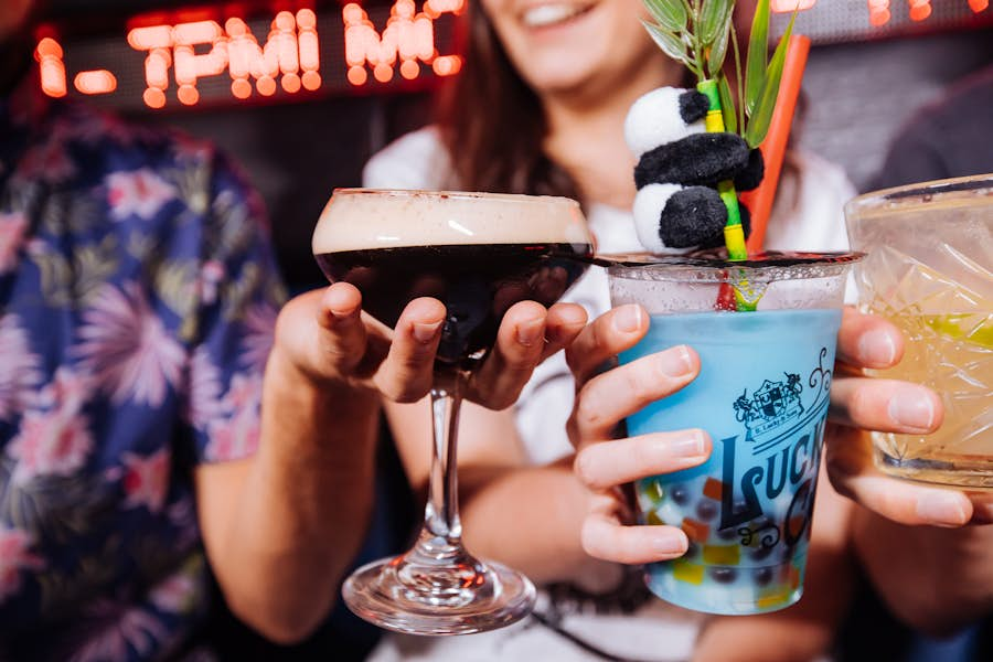 3 people toasting with cocktails