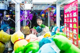 Woman playing a claw machine game