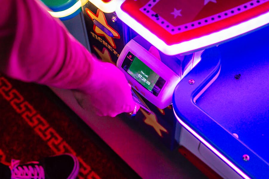 person tapping their arcade game card at B. Lucky & Sons