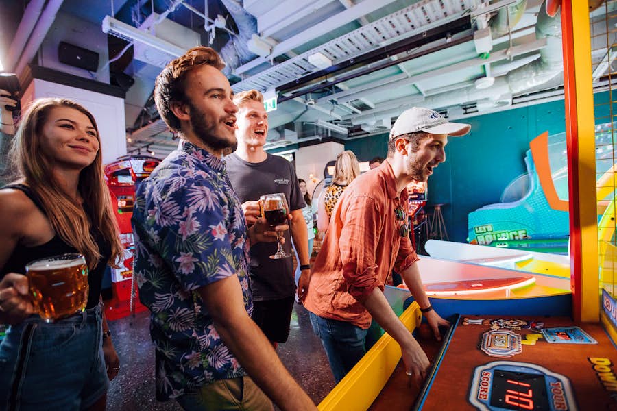group of friends playing arcades