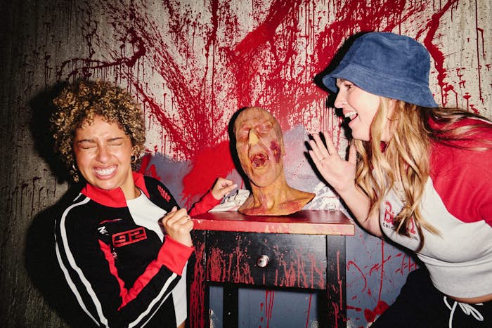Two girls with bloody mannequin head on the Red Manor escape room