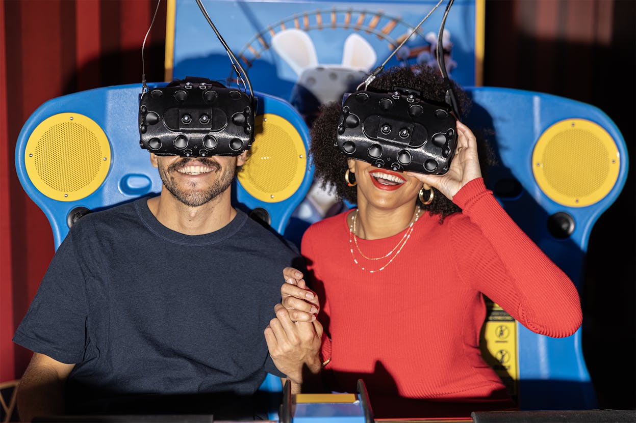 2 people holding hands playing virtual reality