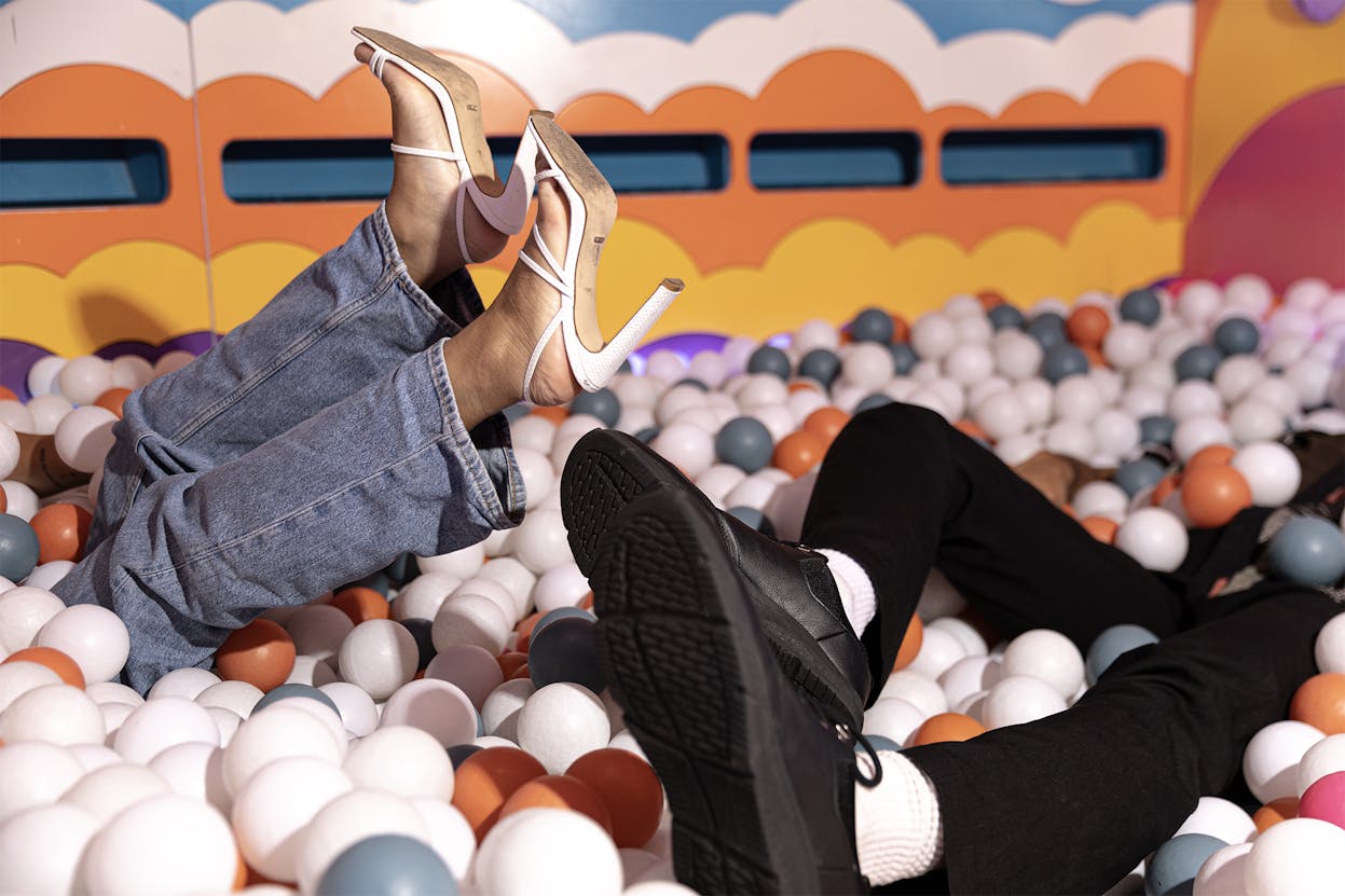 People upside down in a ball pit at Hijinx Hotel