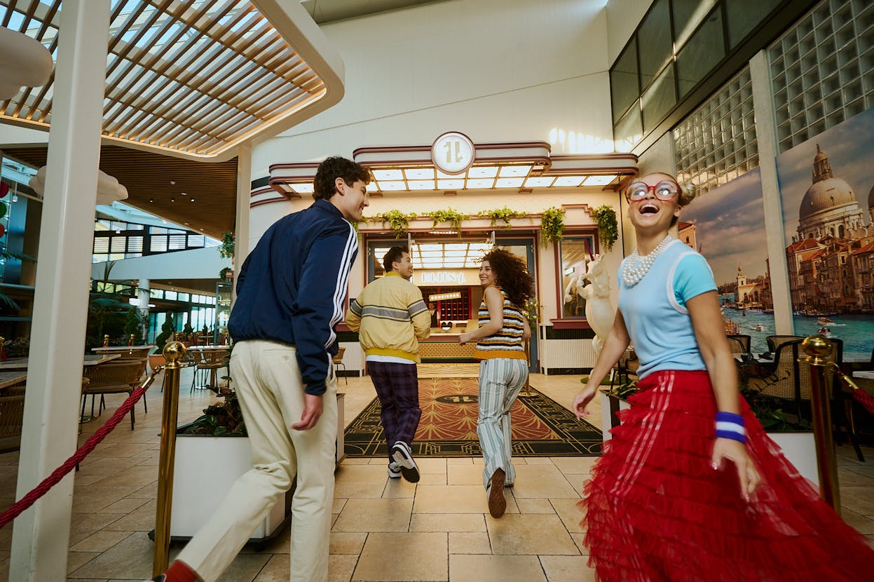 Friends running to the entrance of Hijinx Hotel