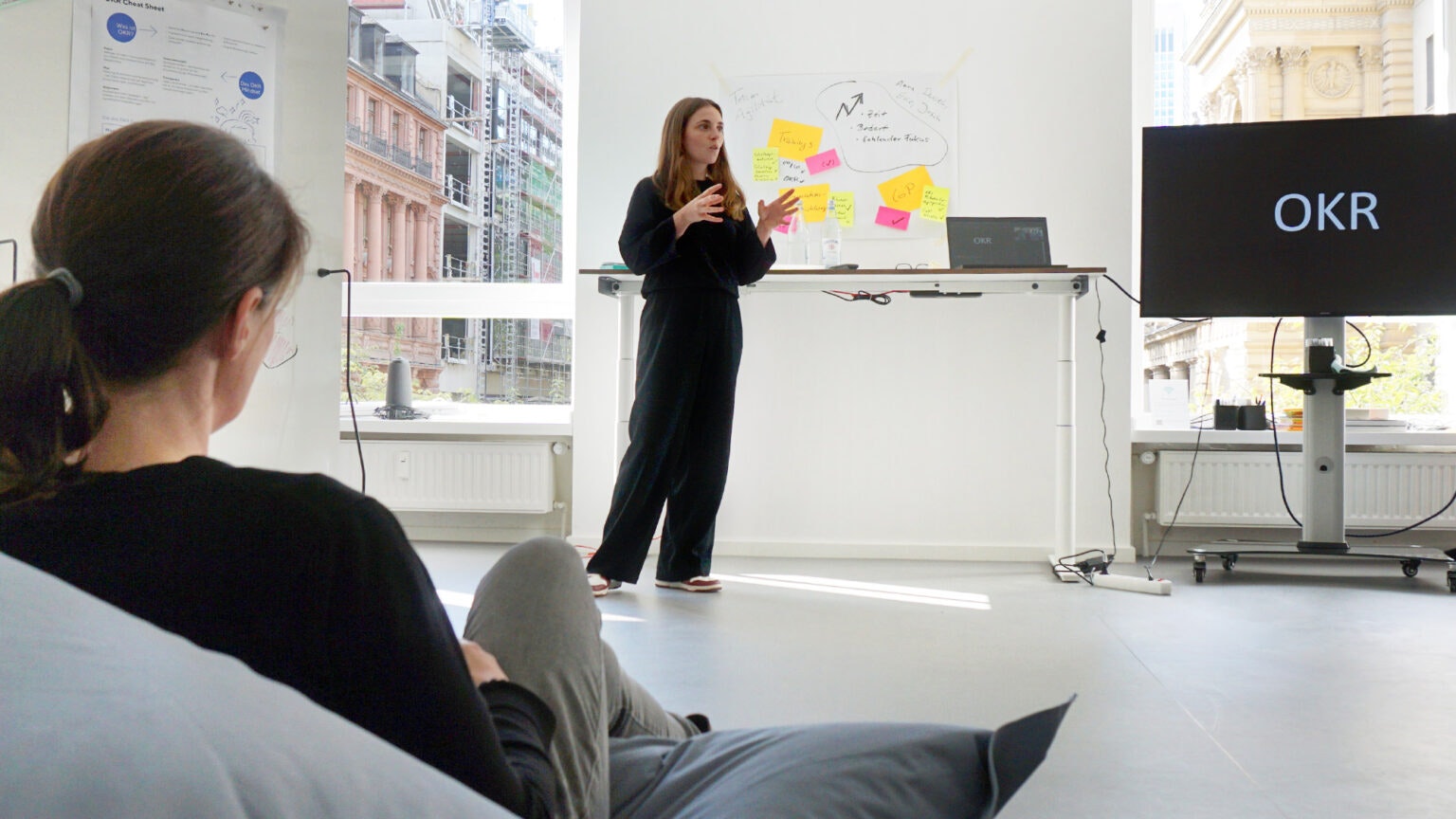 Anna Stark presenting in front of a screen