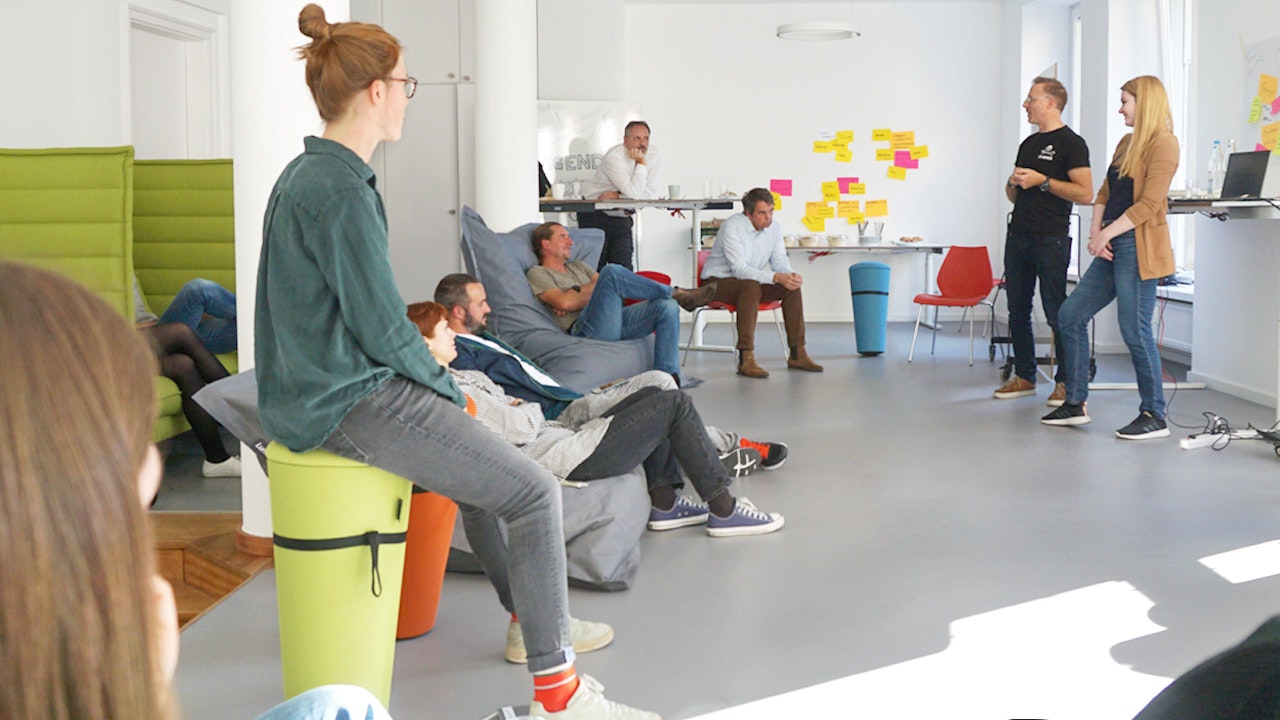 People standing and sitting in a round