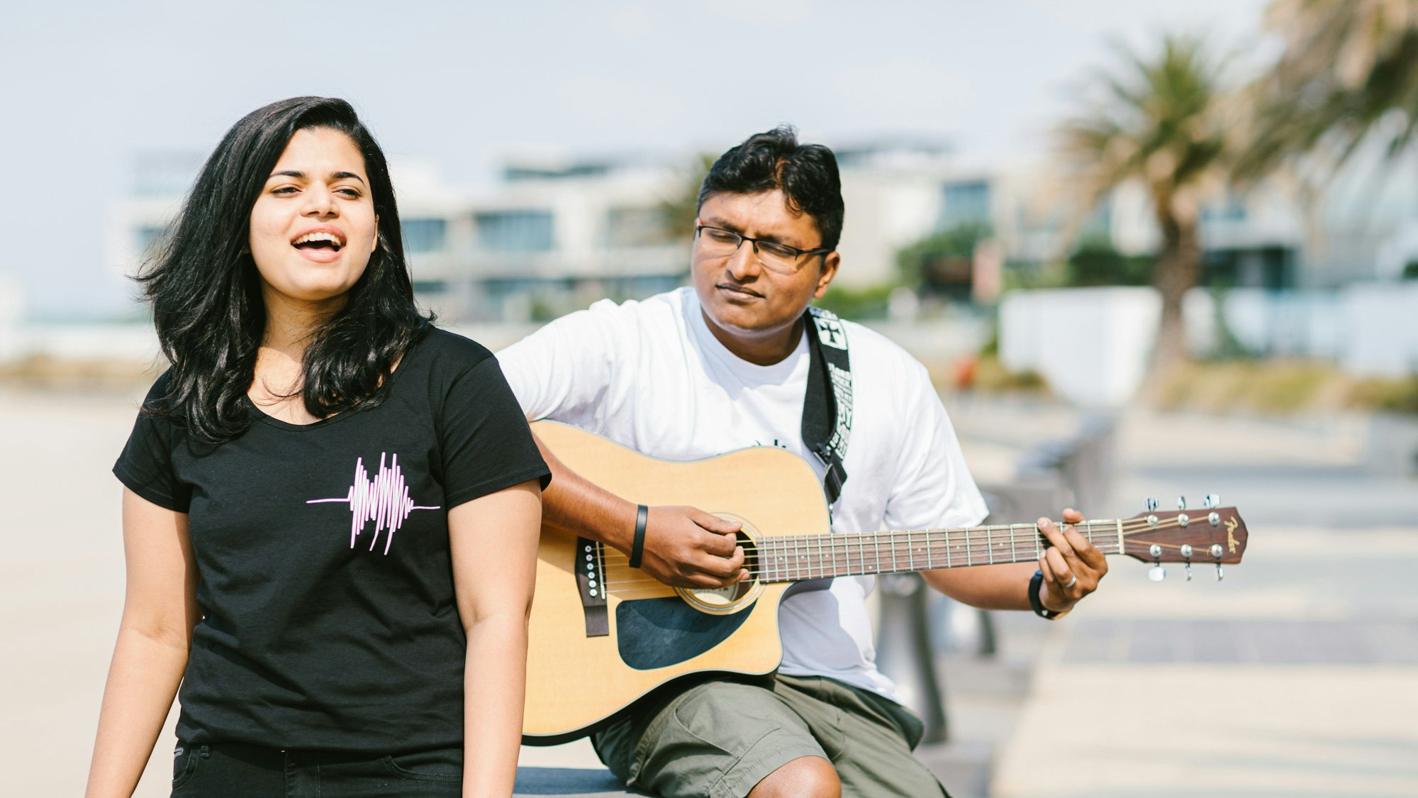 Tissa making music with a guitar player