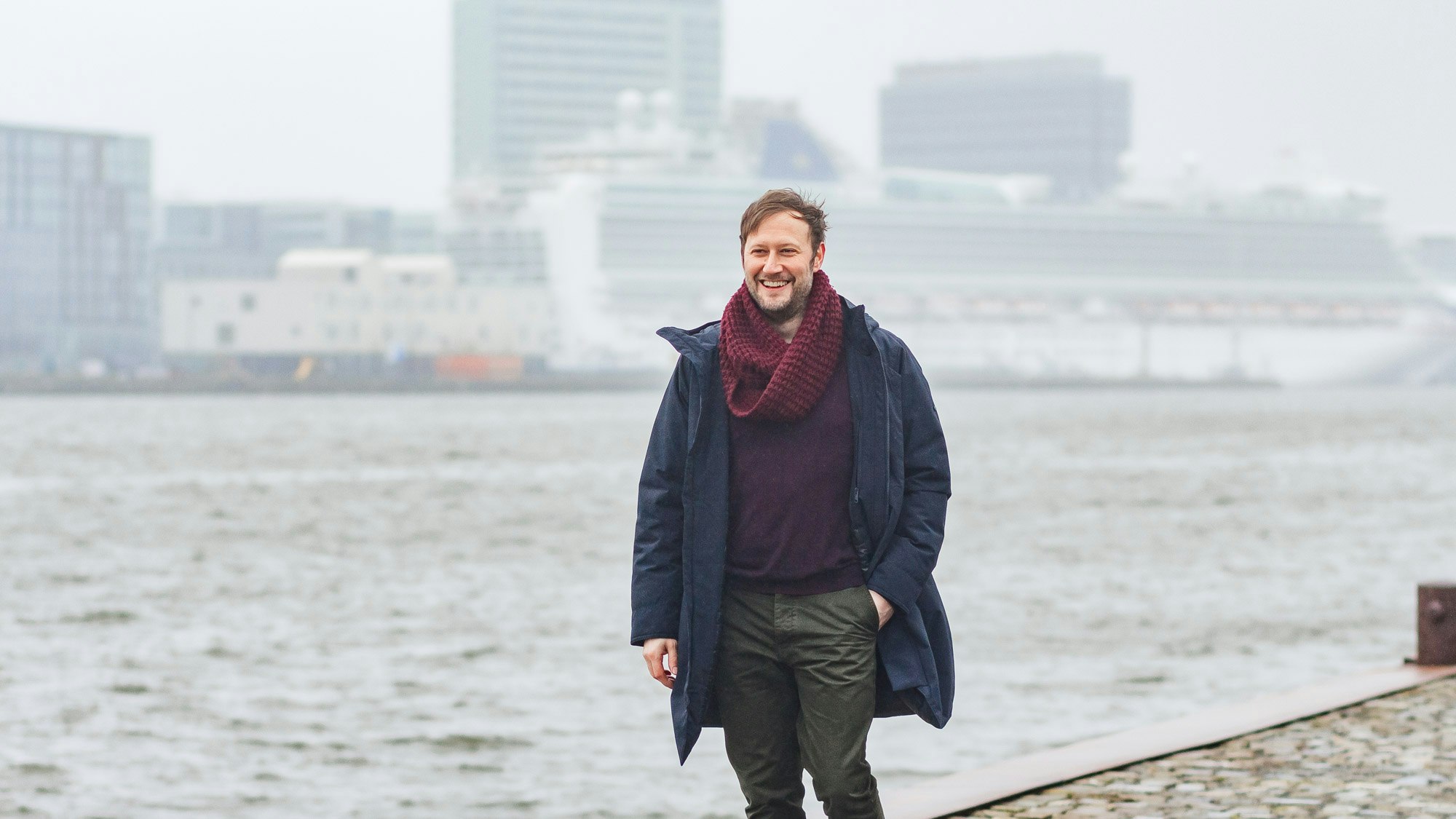 Diego walking along the river IJ in Amsterdam