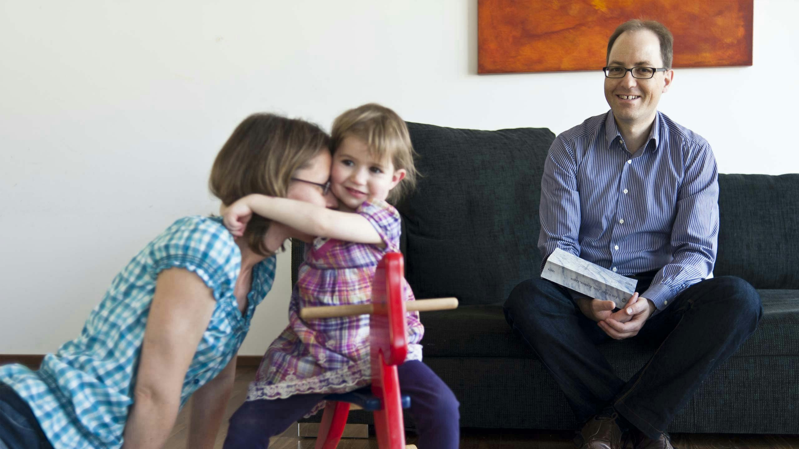 Stephan Mueller looking at his wife and daughter playing