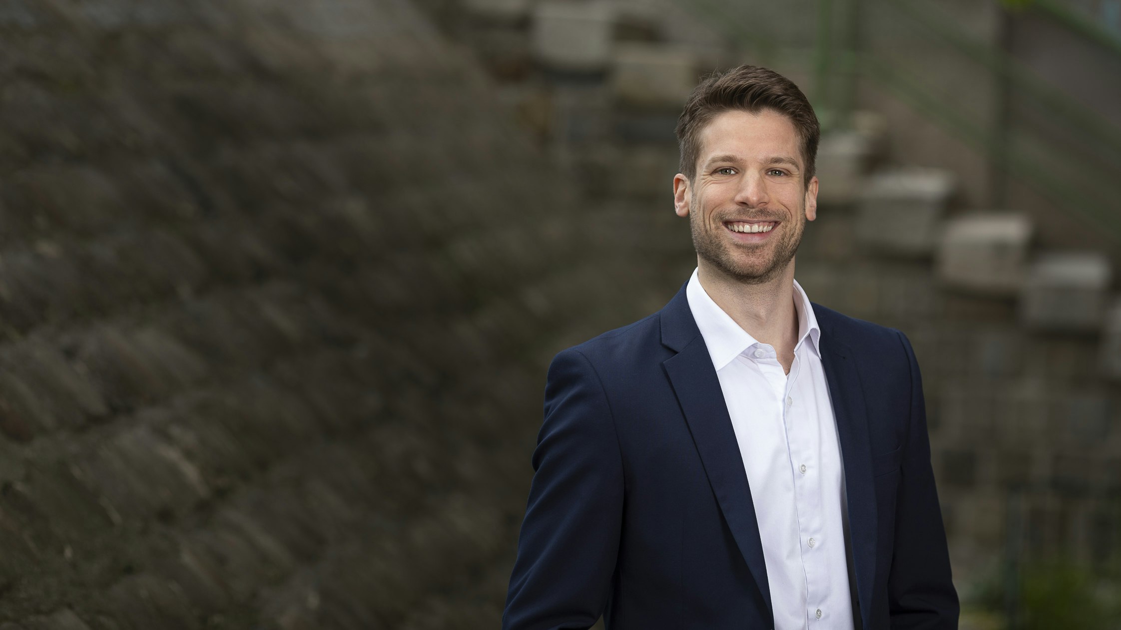 Man in suit smiles at camera