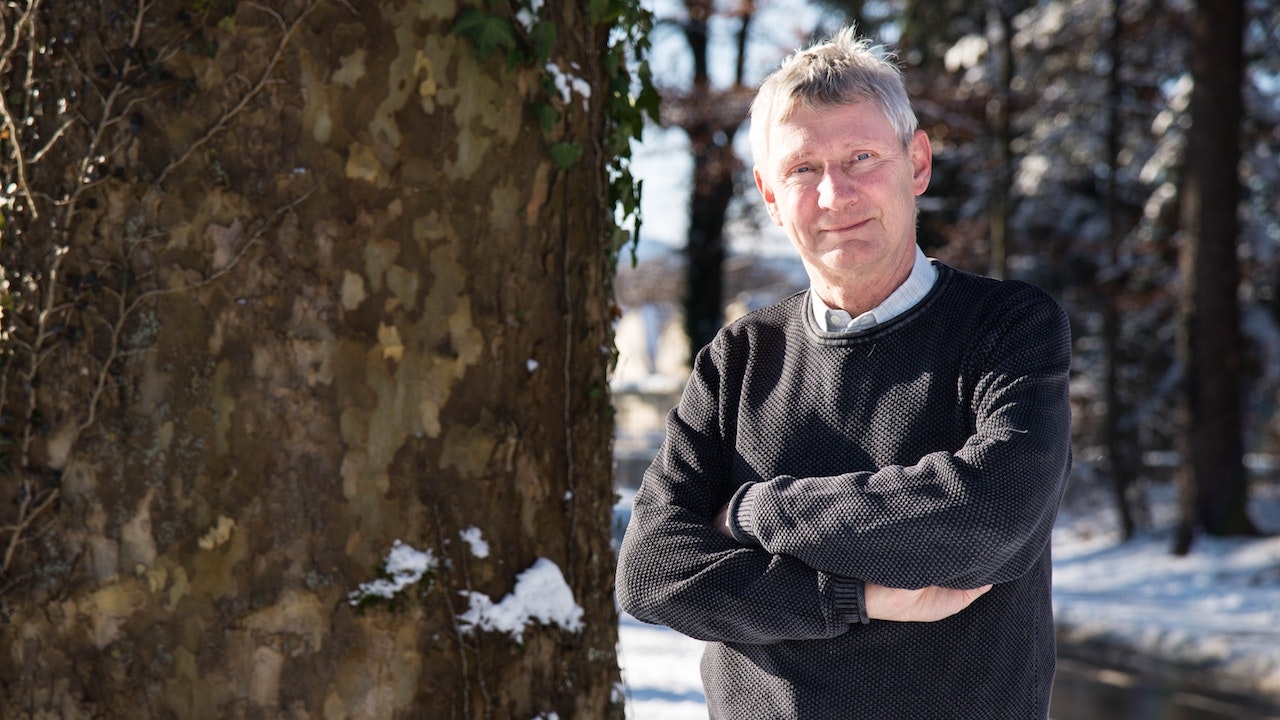 Hans Albrecht Bartels in einem schwarzen Pullover neben einem Baum