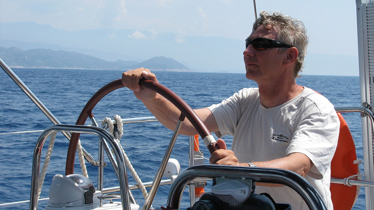 Hans Albrecht Bartels steering a boat.