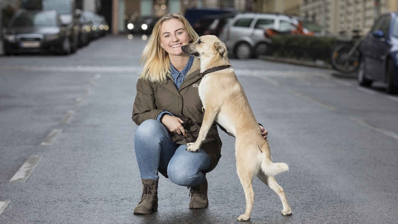 Jacqueline Pregesbauer on a street with her dog Margot.