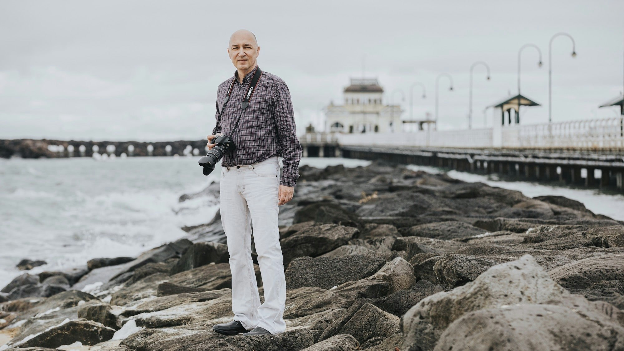 Stefan vom Bruch on a pier with his camera.