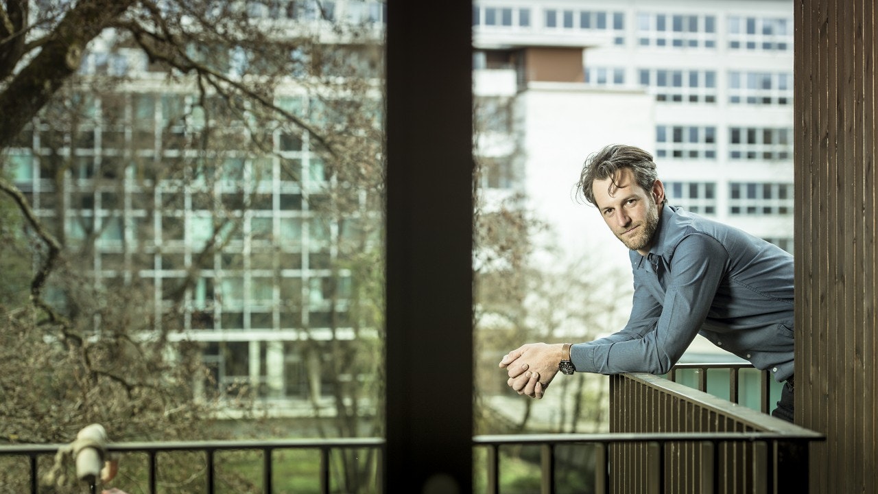 Man in shirt leaning on a railing