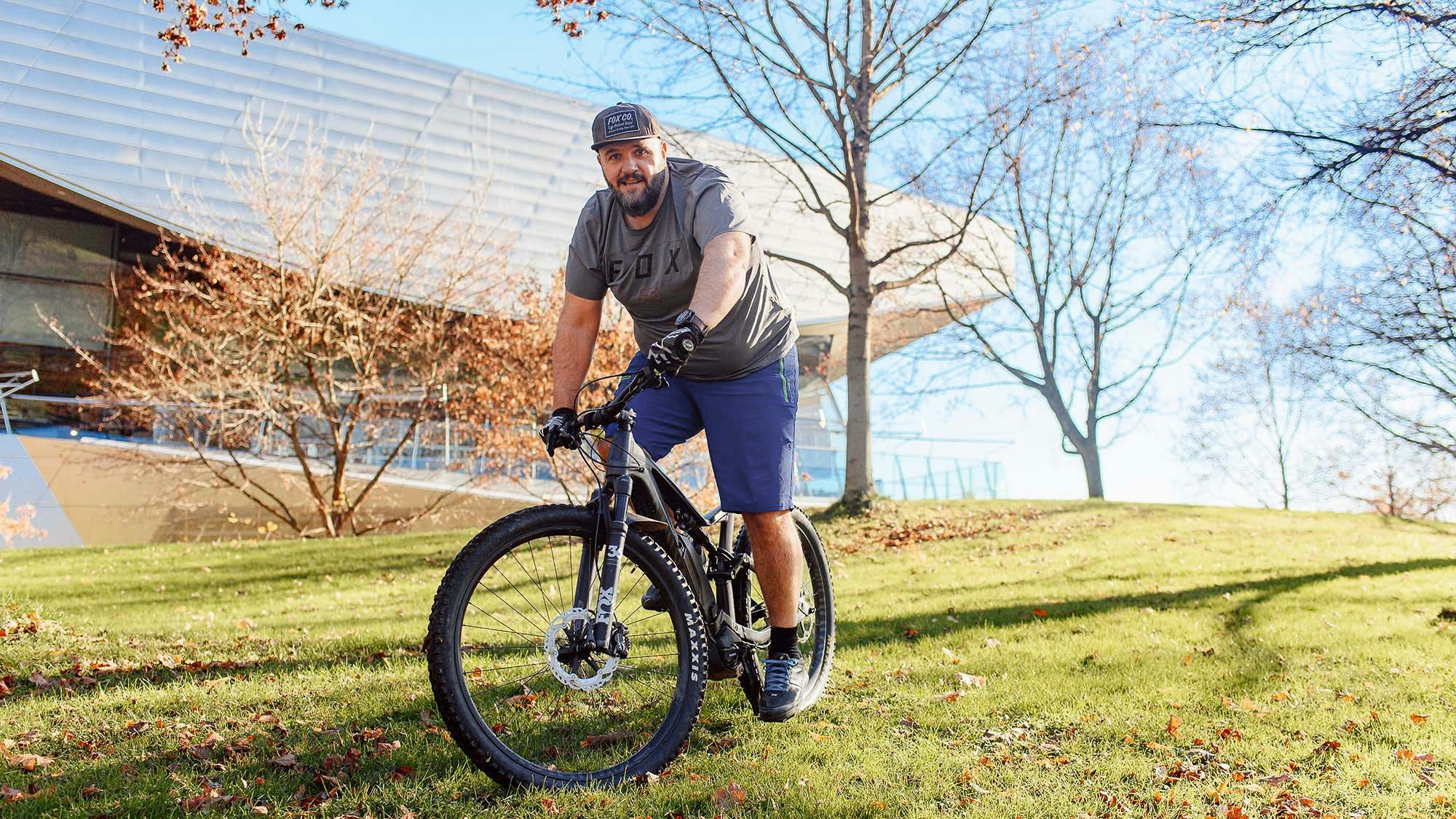 Stefan Kotulla on a mountain bike, outside in summer.
