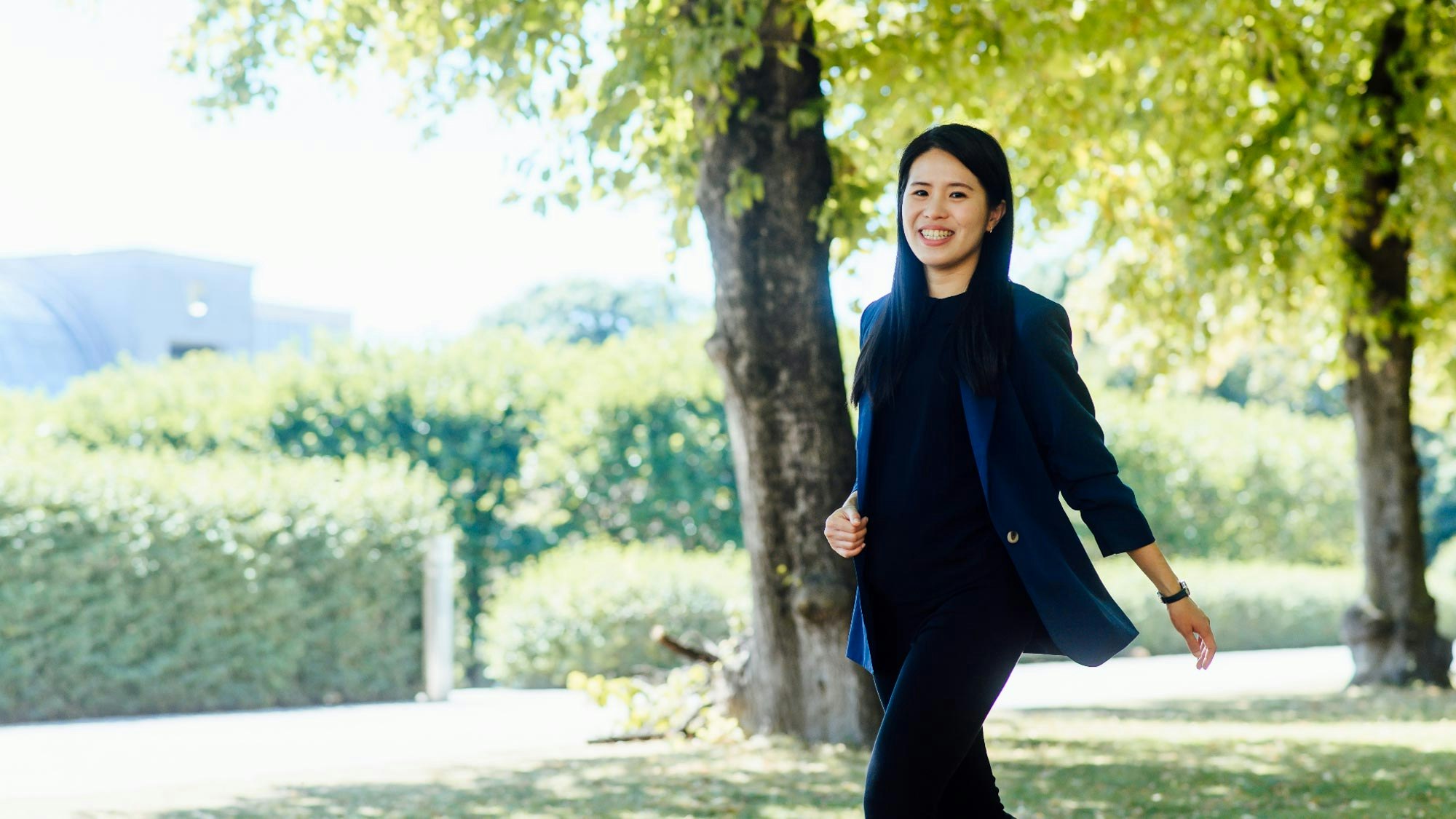 Yi-Chen Liu is walking through a park during summer.