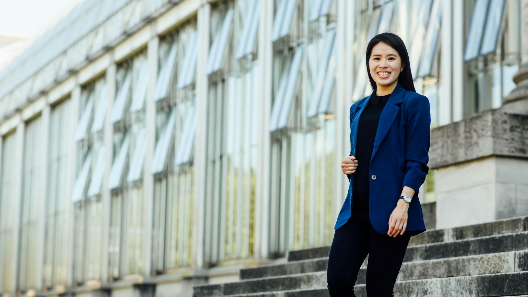 Yi-Chen Liu in business clothes in front of an office building.
