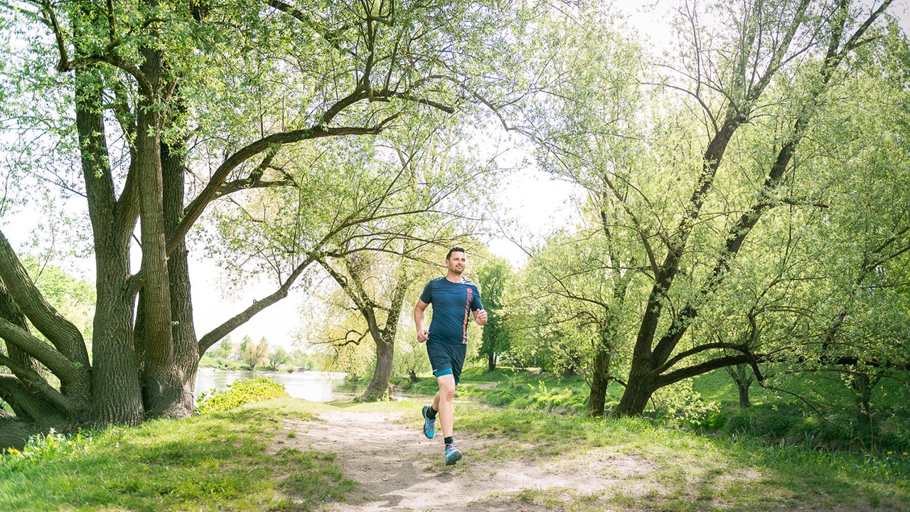 Andreas running near the river.