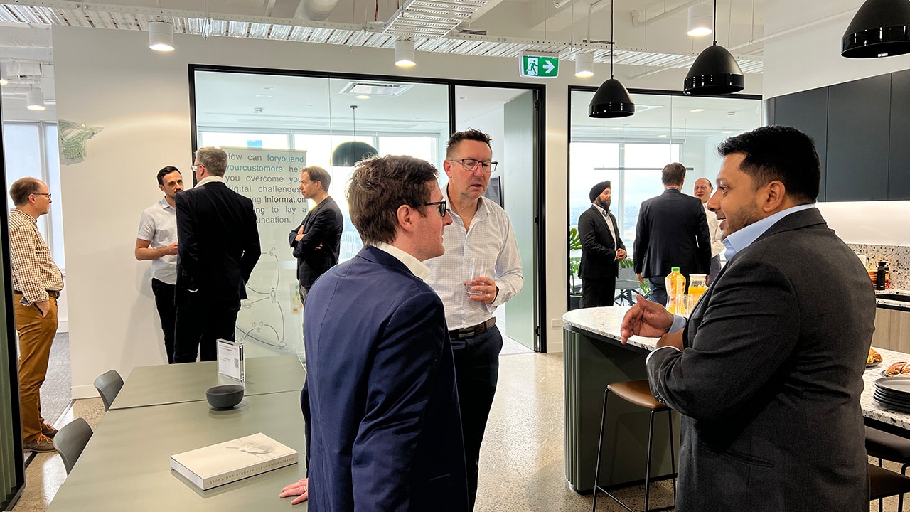 Guests chat while enjoying their coffee.