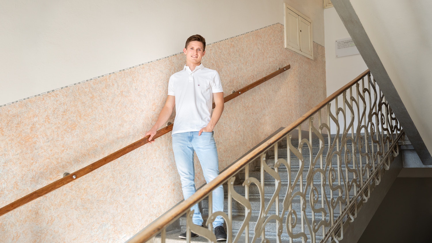 Cristoph standing on stairstep holding the handrail