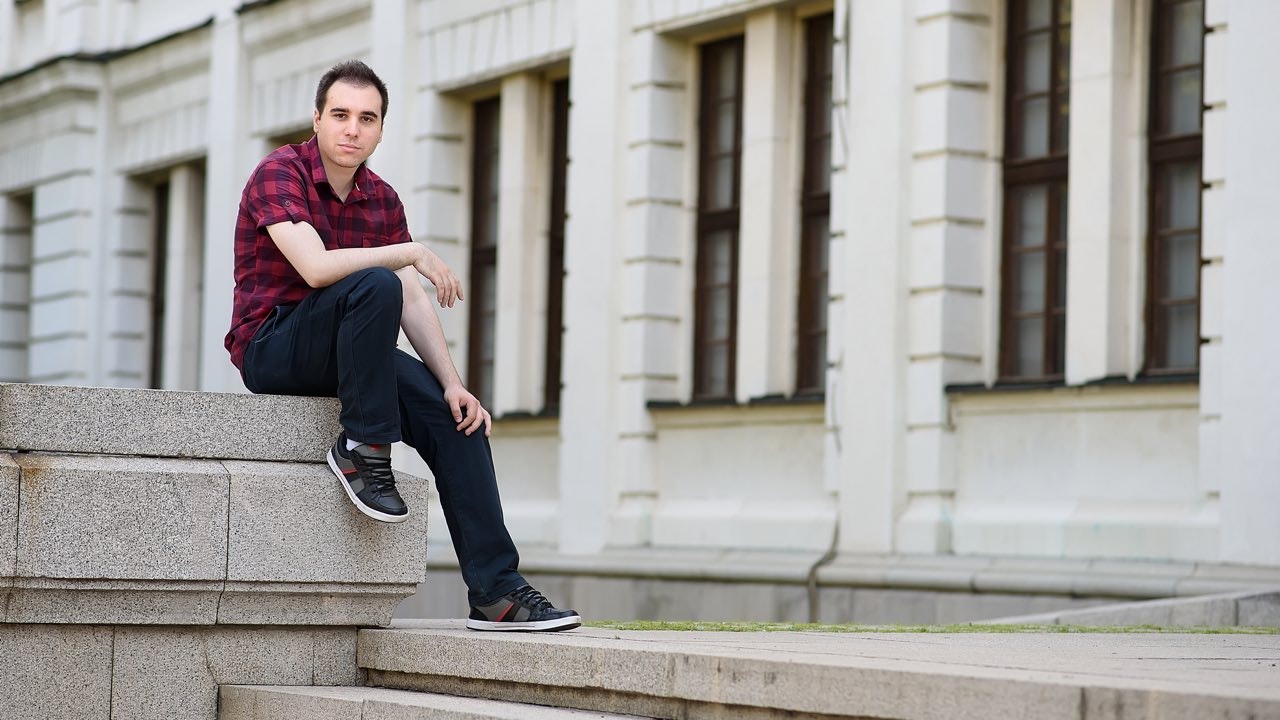 Person sitting on concrete lodge