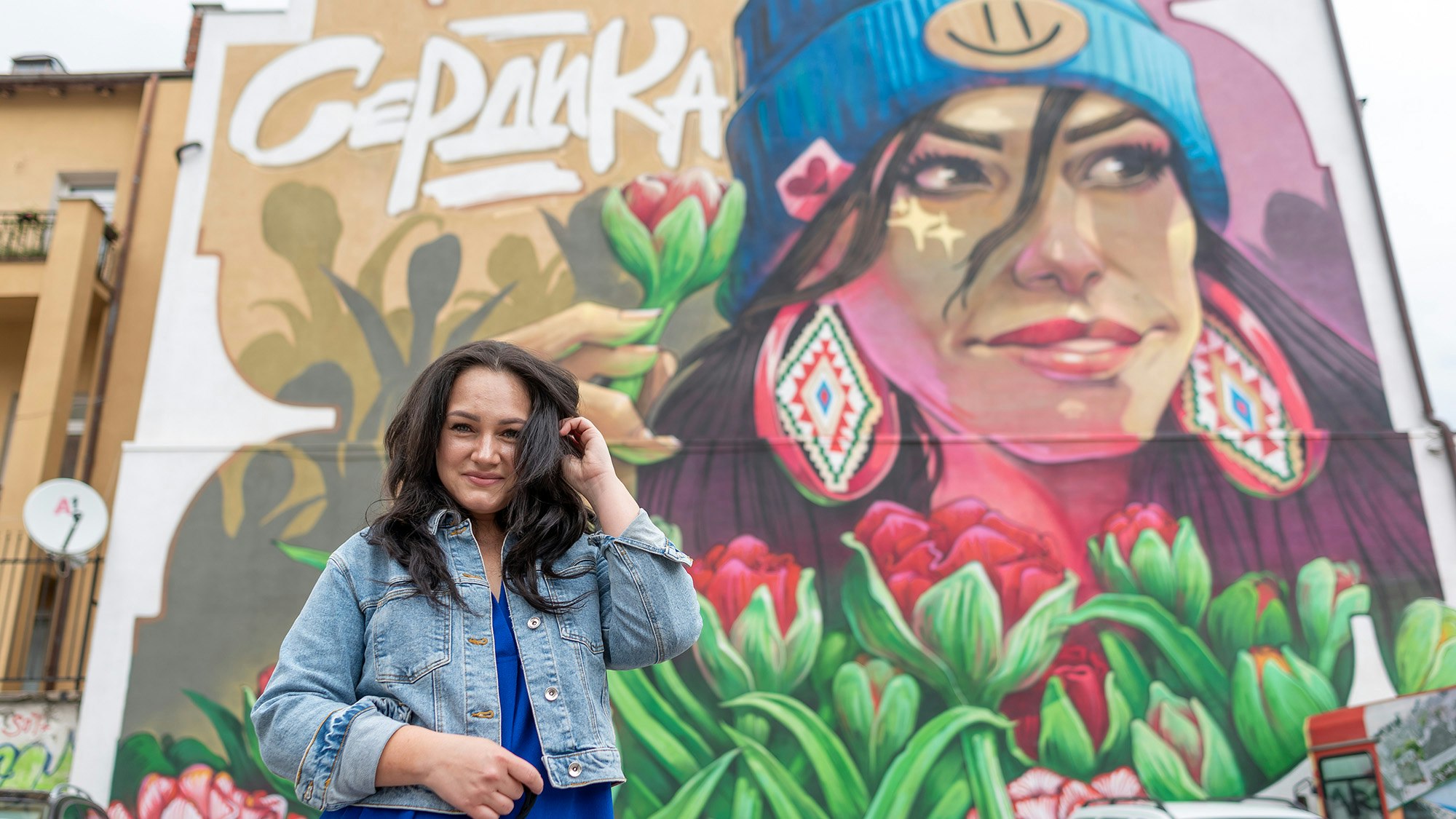 Person standing in front of a mural painting