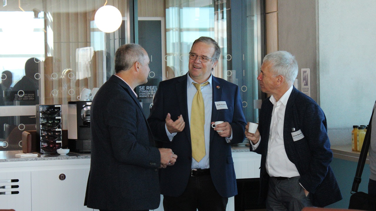 Three men in a suit in an engaged conversation