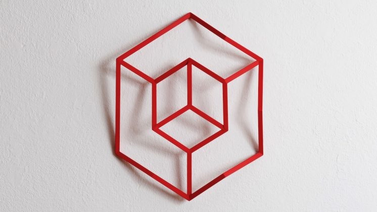 Artwork, red geometrically shaped object, centered.