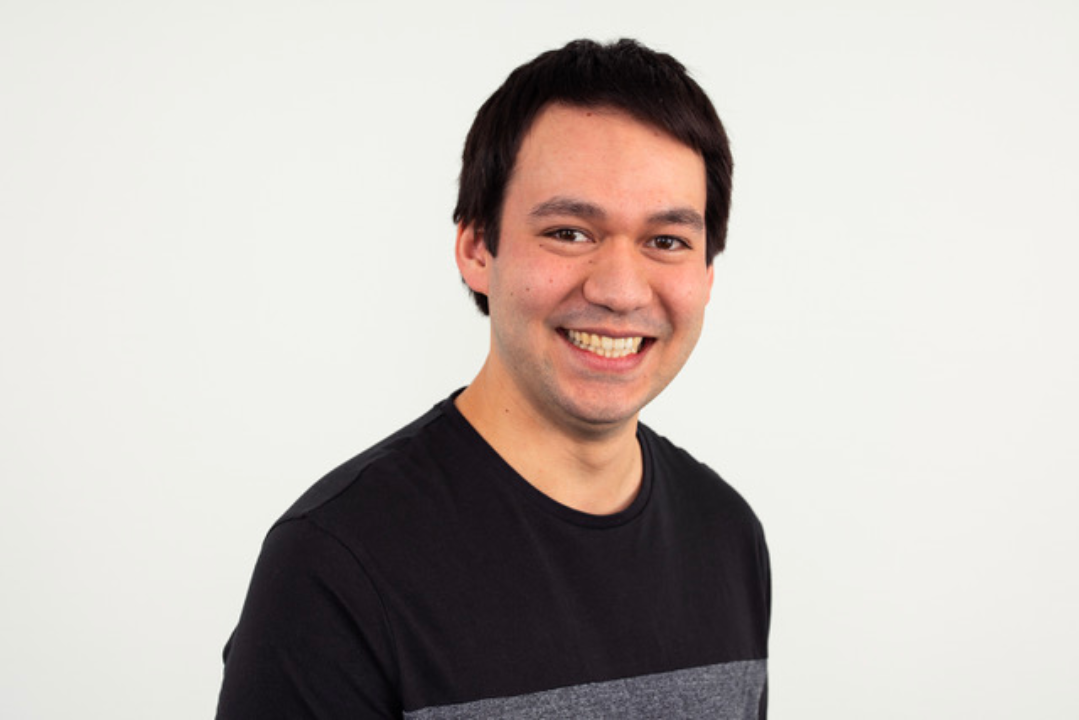 profile photo of a young man with dark hair smiilng