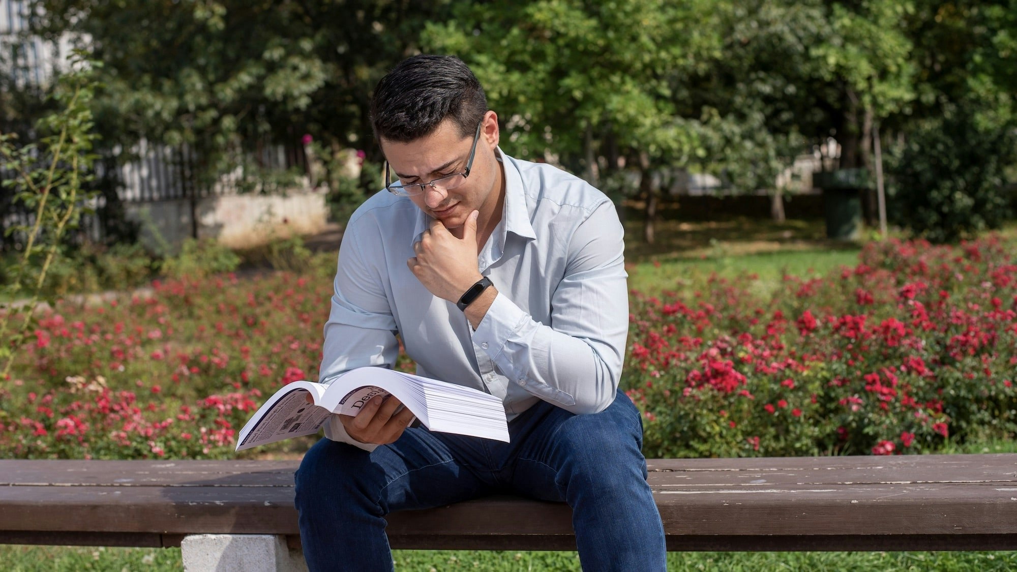 Young man reading in the park.