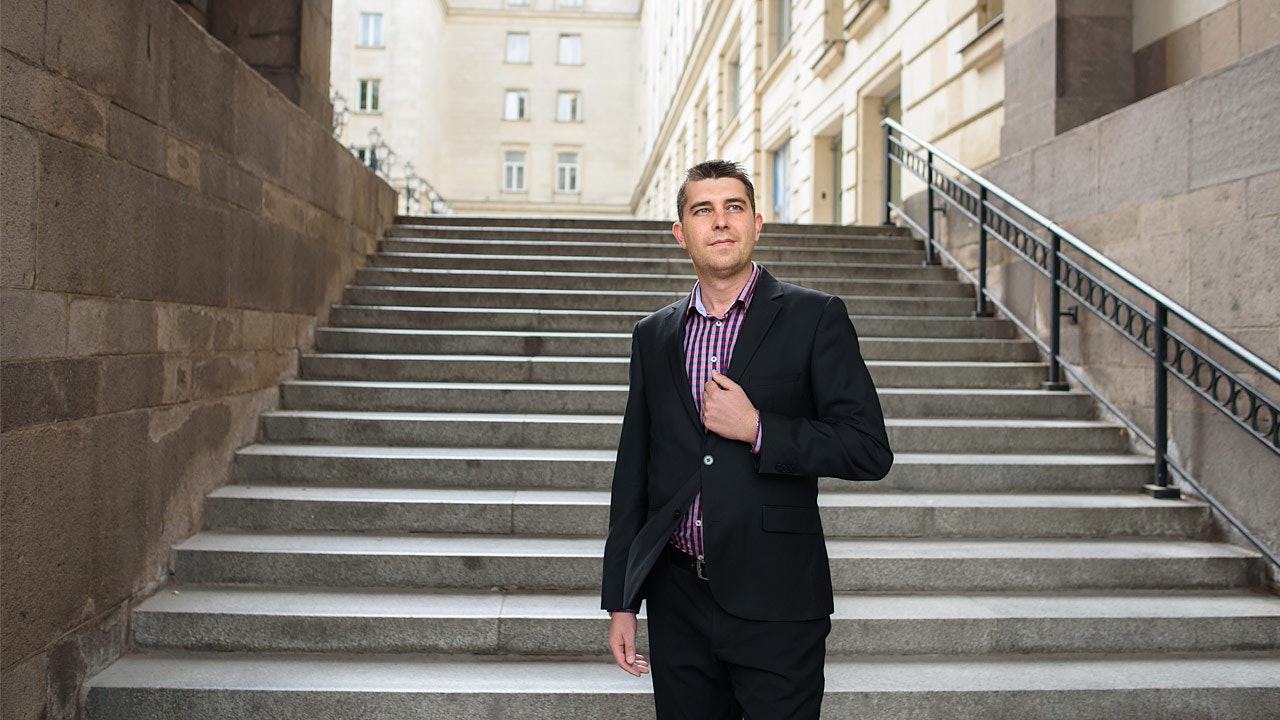 Nikolay standing in the bottom of stone stairs.