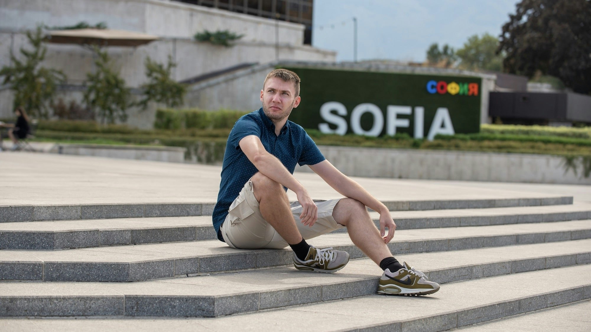 Pavel sitting on stone stairs.