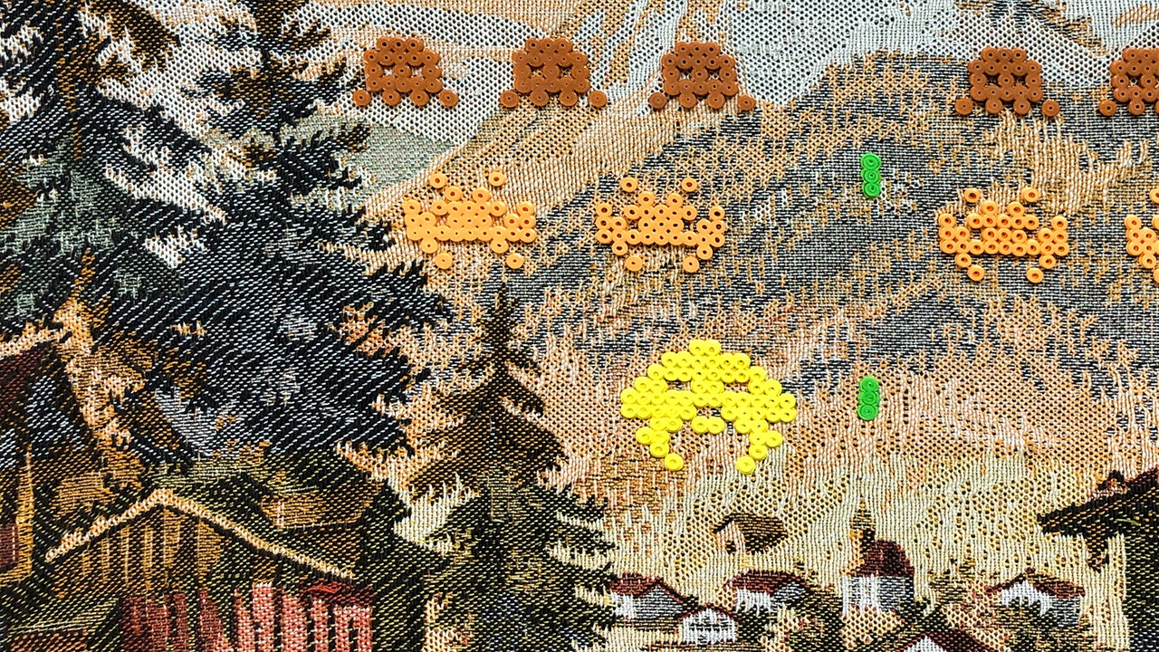 stiched artwork showing embroided packman figures