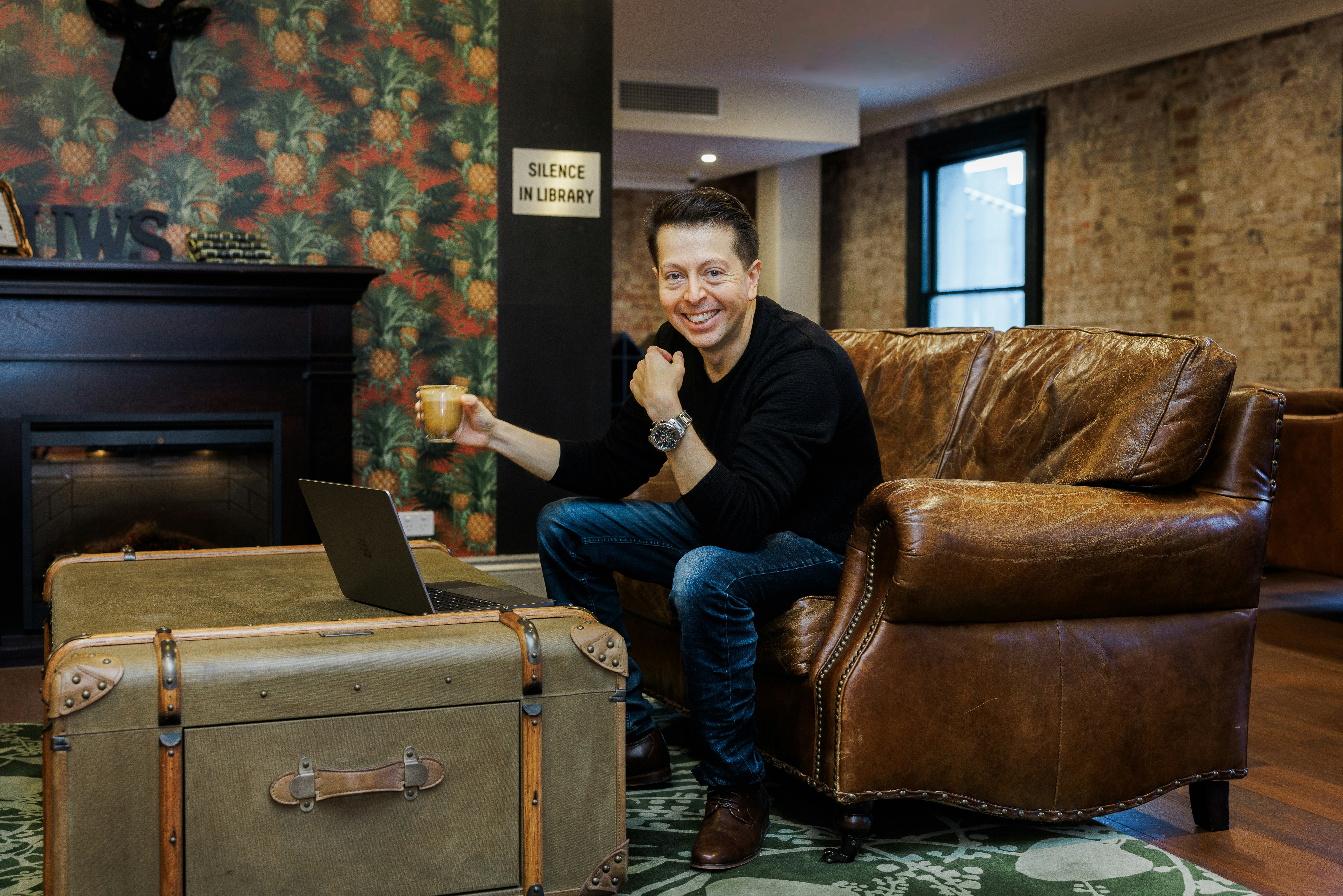 Carlos smiling with coffee