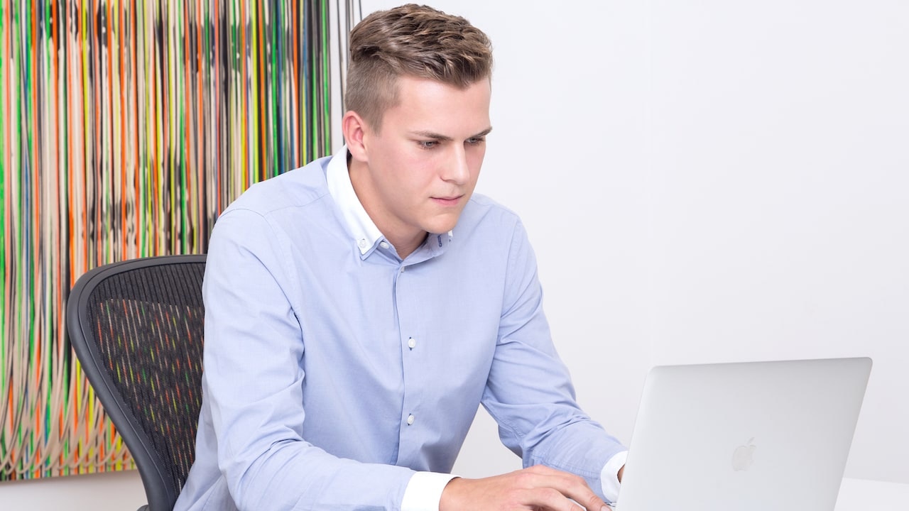 Julian sits in front of his laptop.