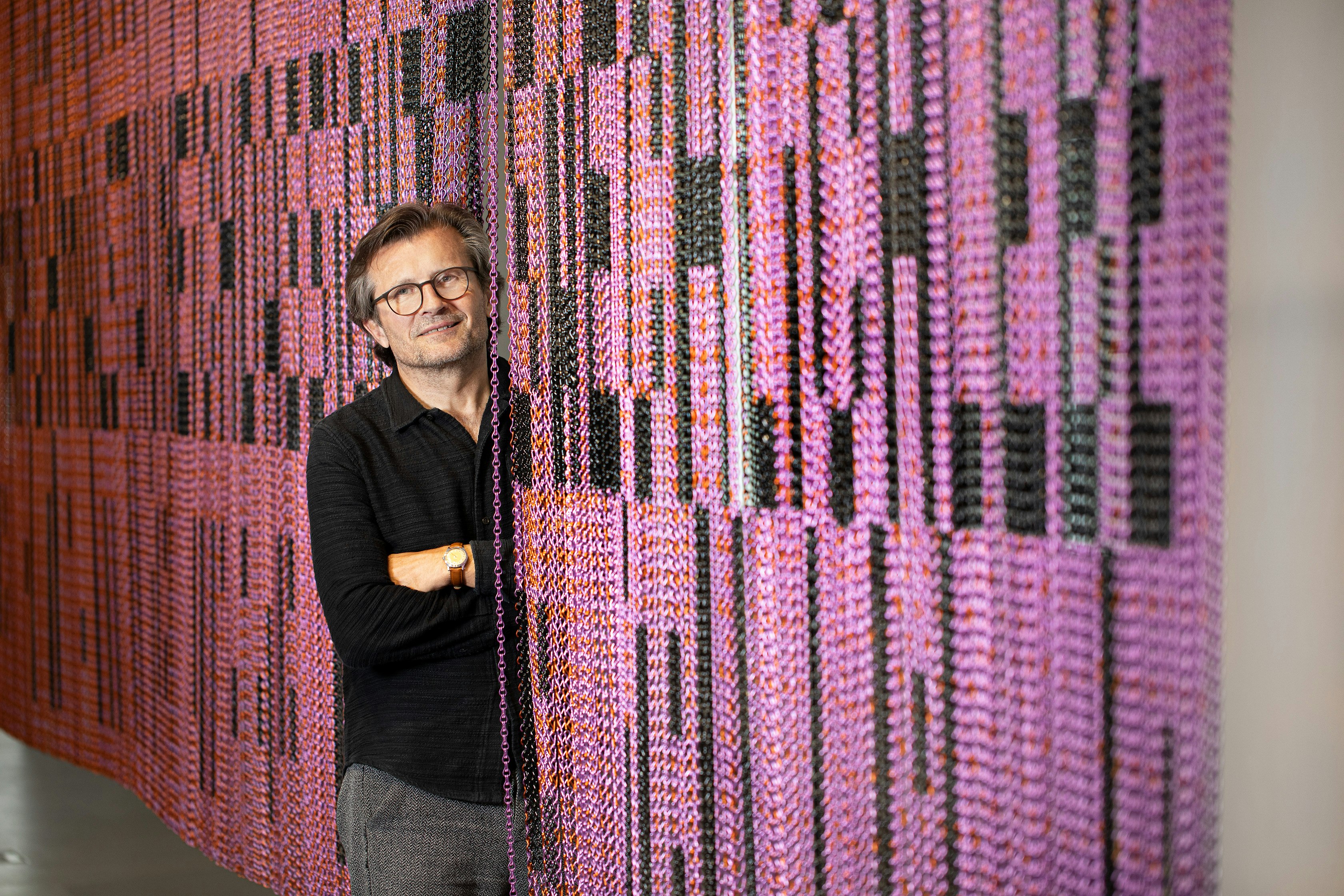 artist Marbod Fritsch alongside a pink and black installation