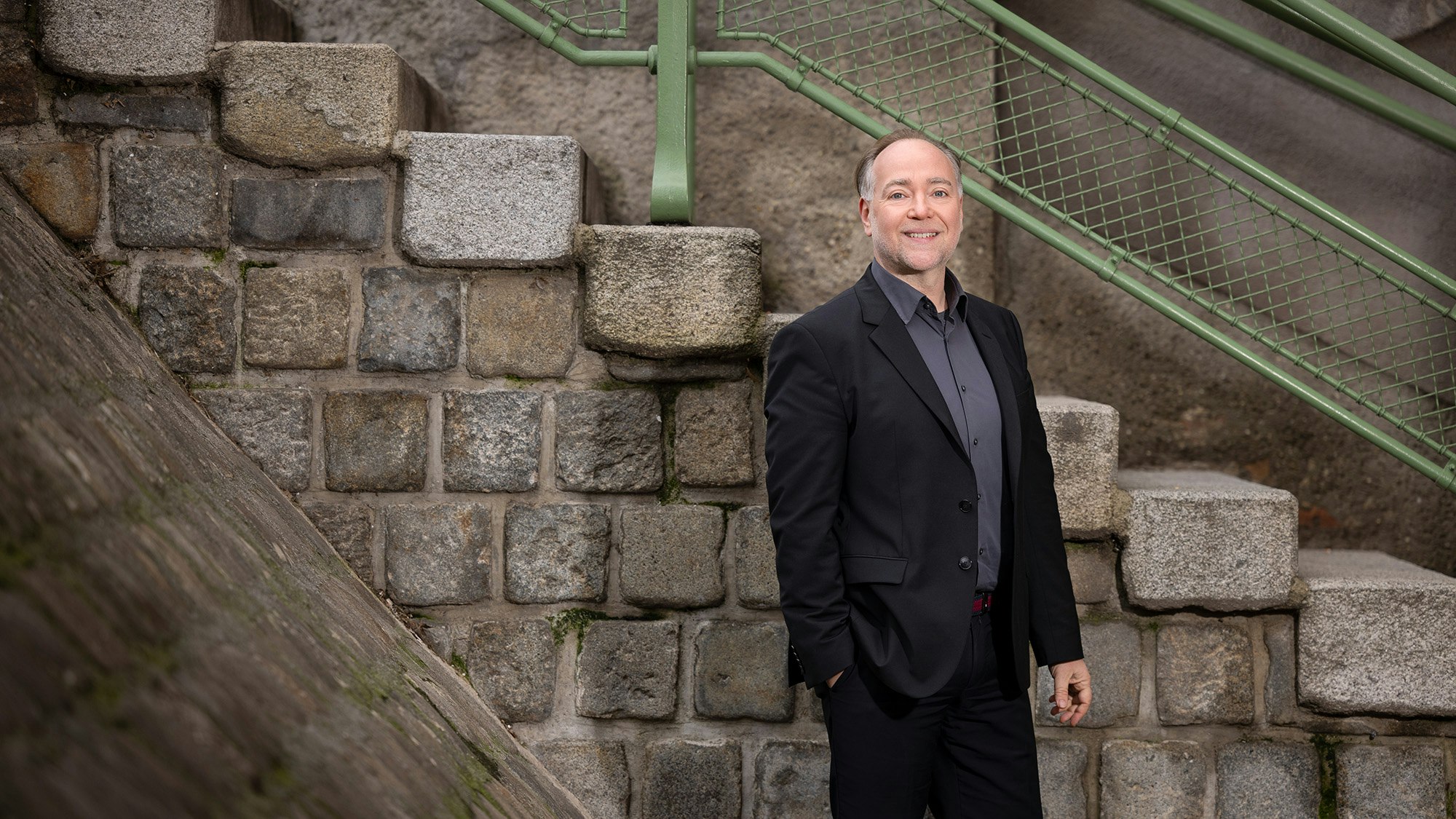 Eric standing in front of a staircase.