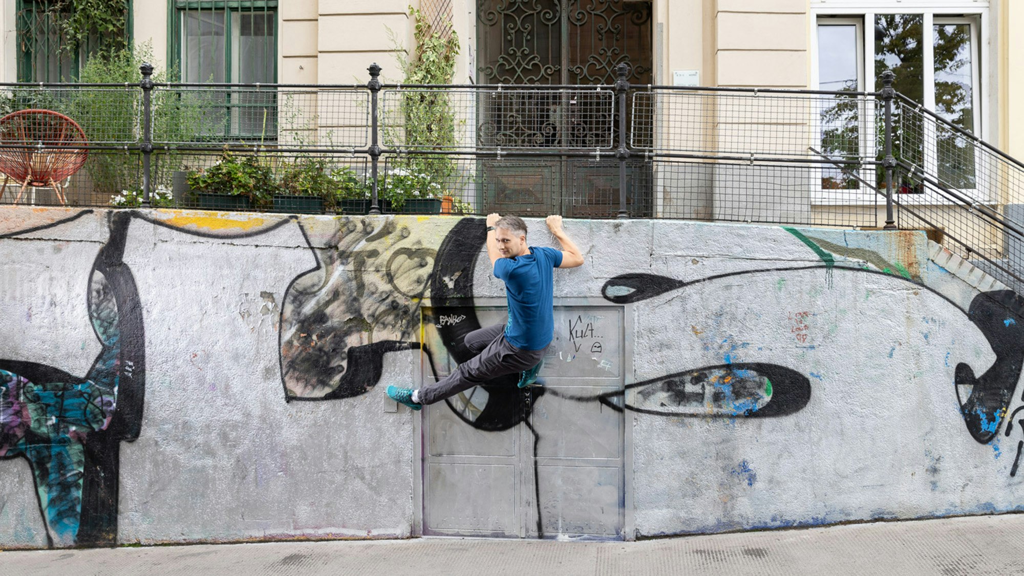 Martin climbs a wall.