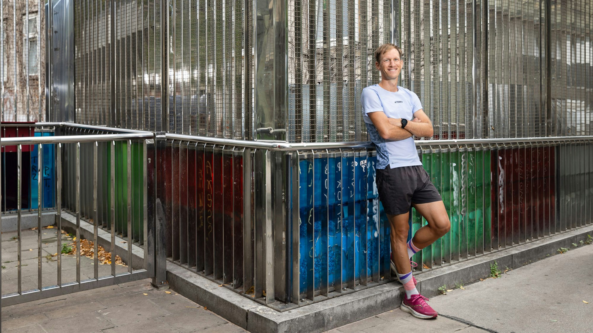 Lukas leaning in front of the sports cage.