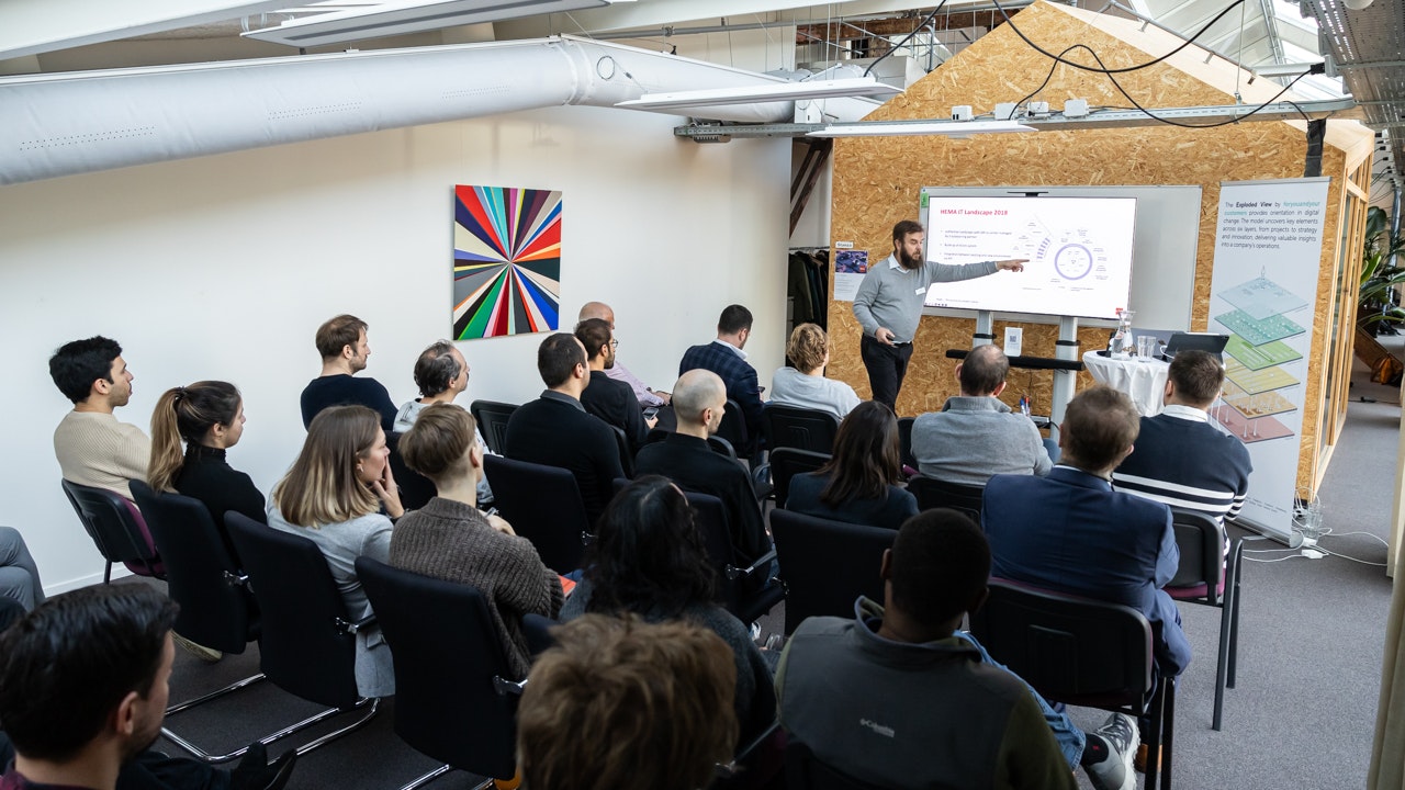 Alex presenting in front of an audience