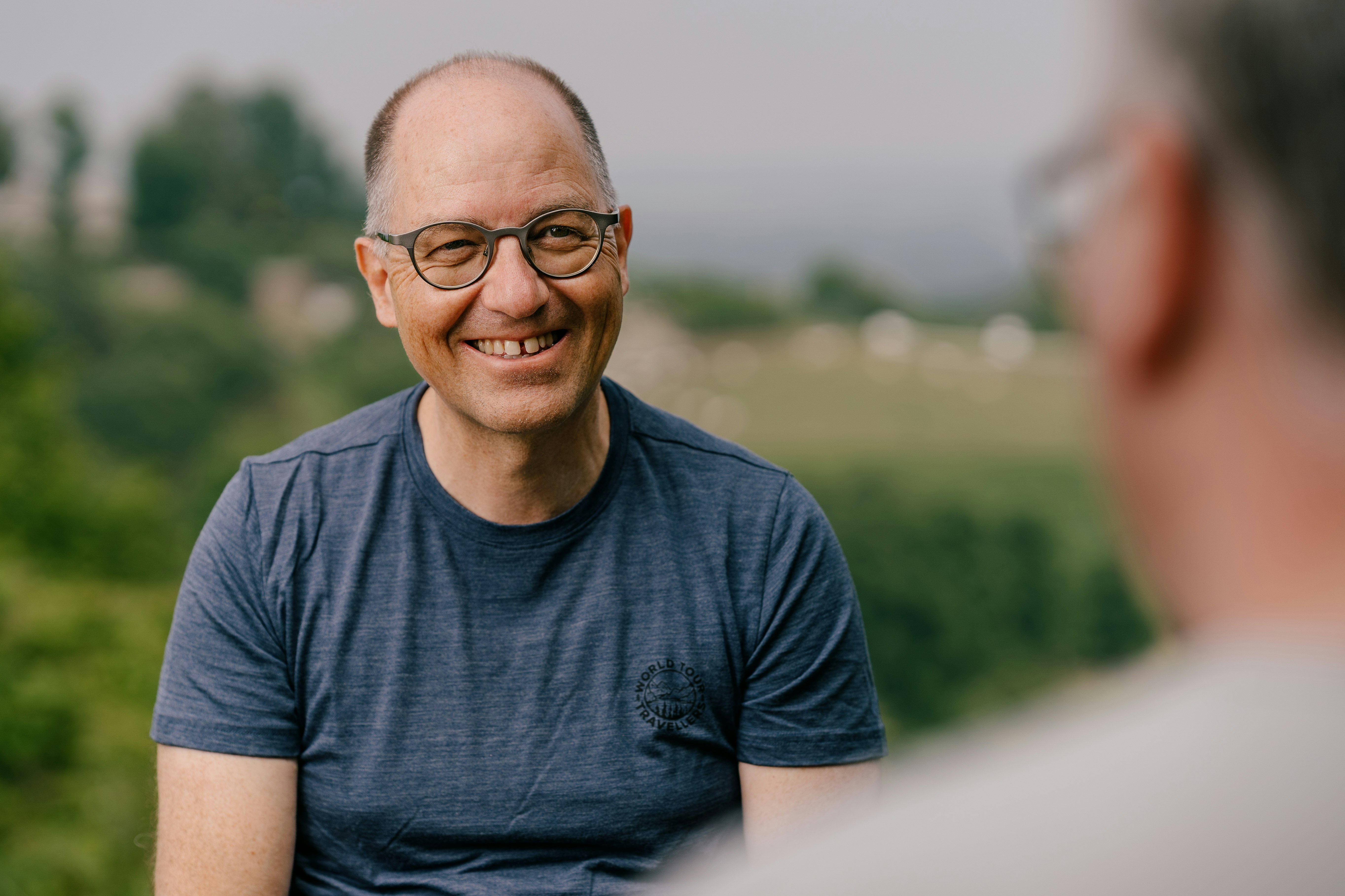 Stephan Müller, smiling in a dialog with someone