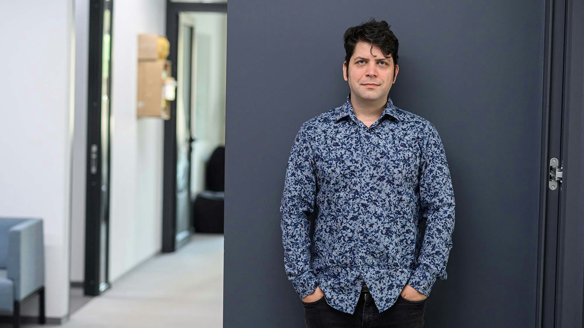Man standing next to a wall