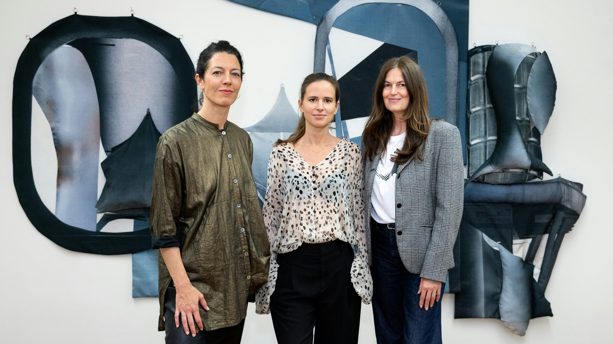 curator and artits in front of installation