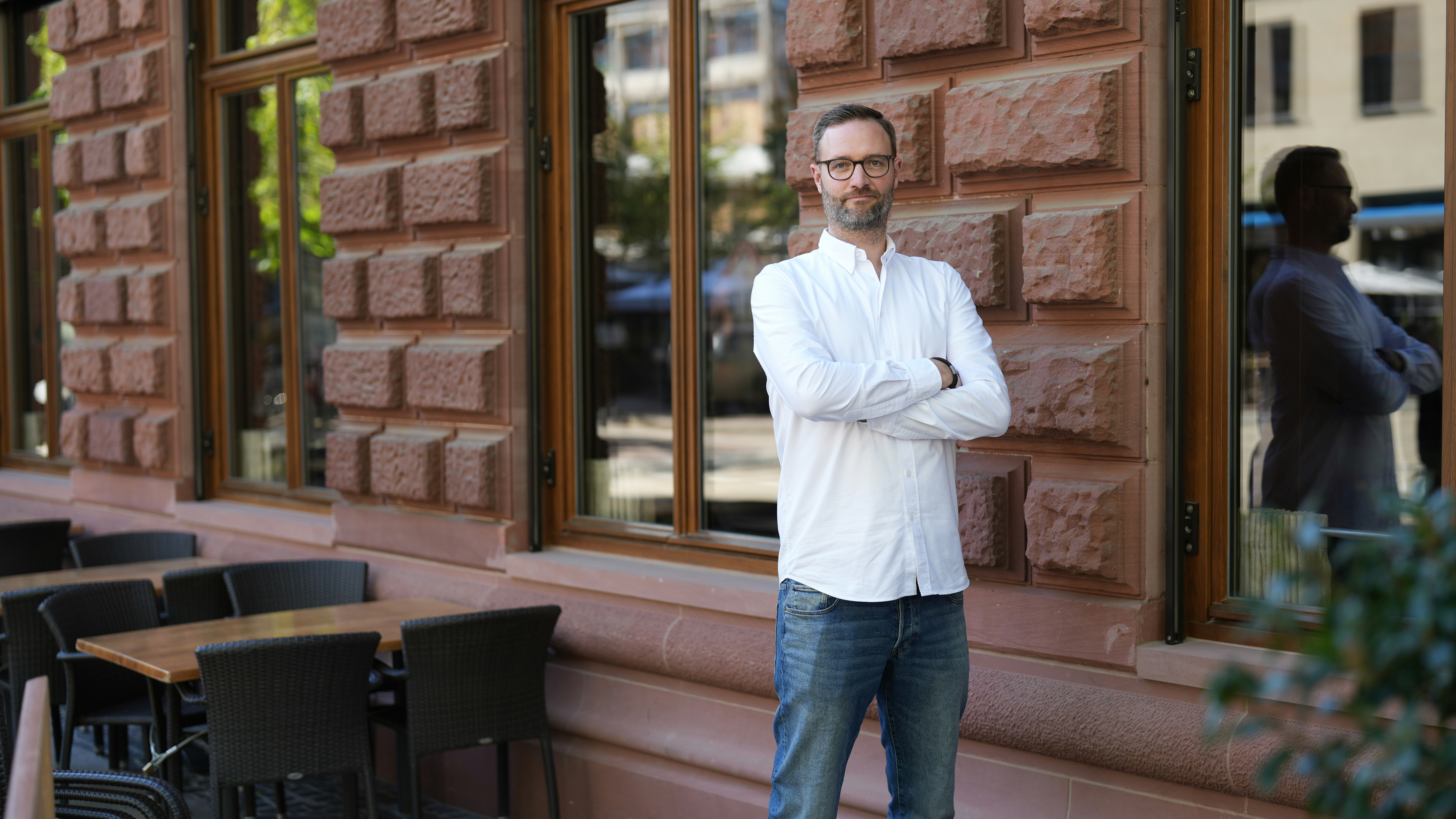 Sebastian Immer standing in front of a house