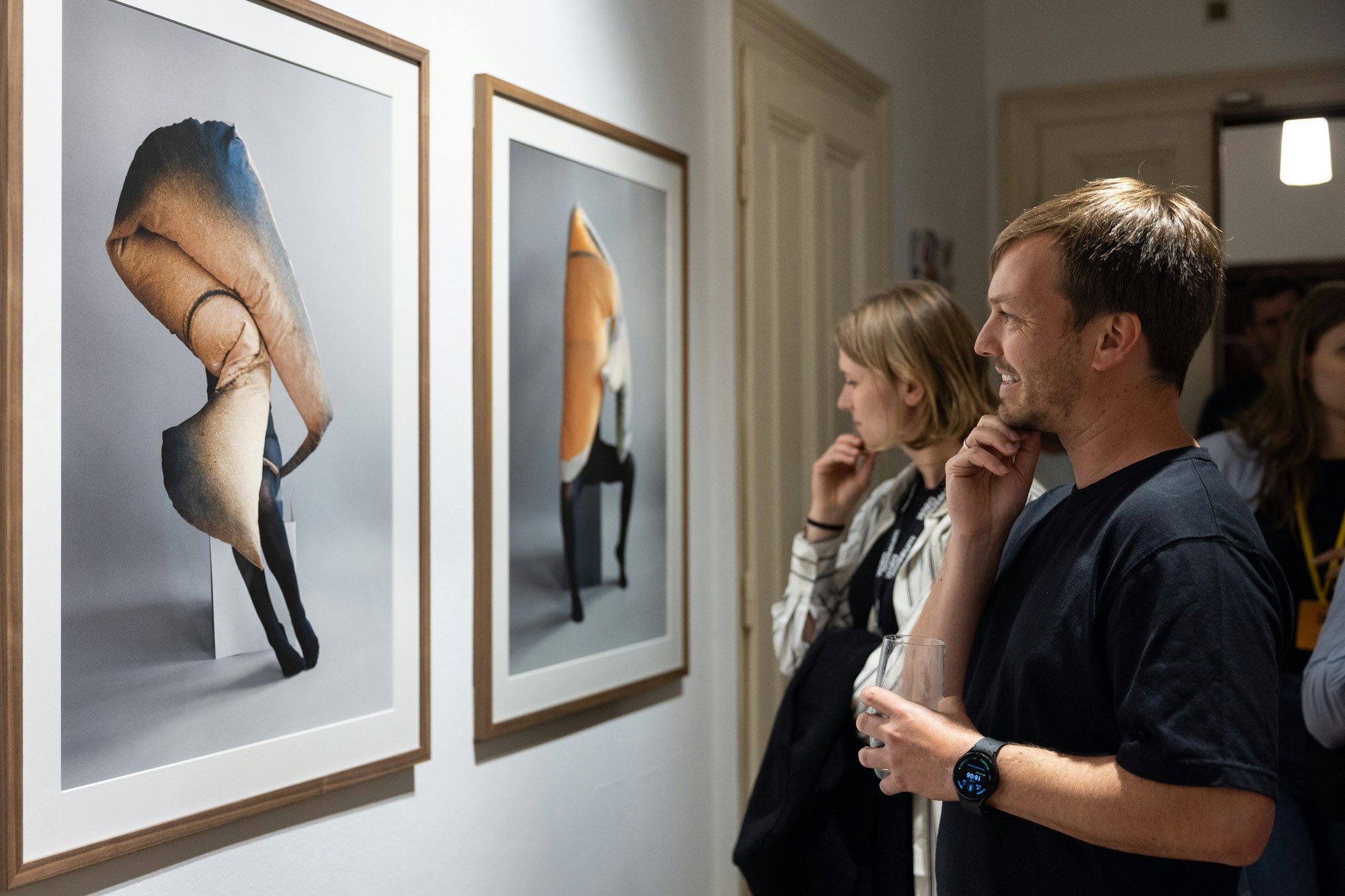 A guest is looking at the art on the wall
